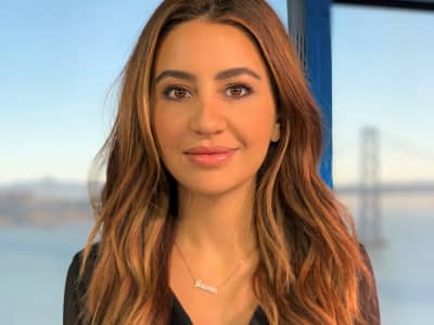 Yasmin Khorram with mixed yellow and black hair and a black T-shirt.